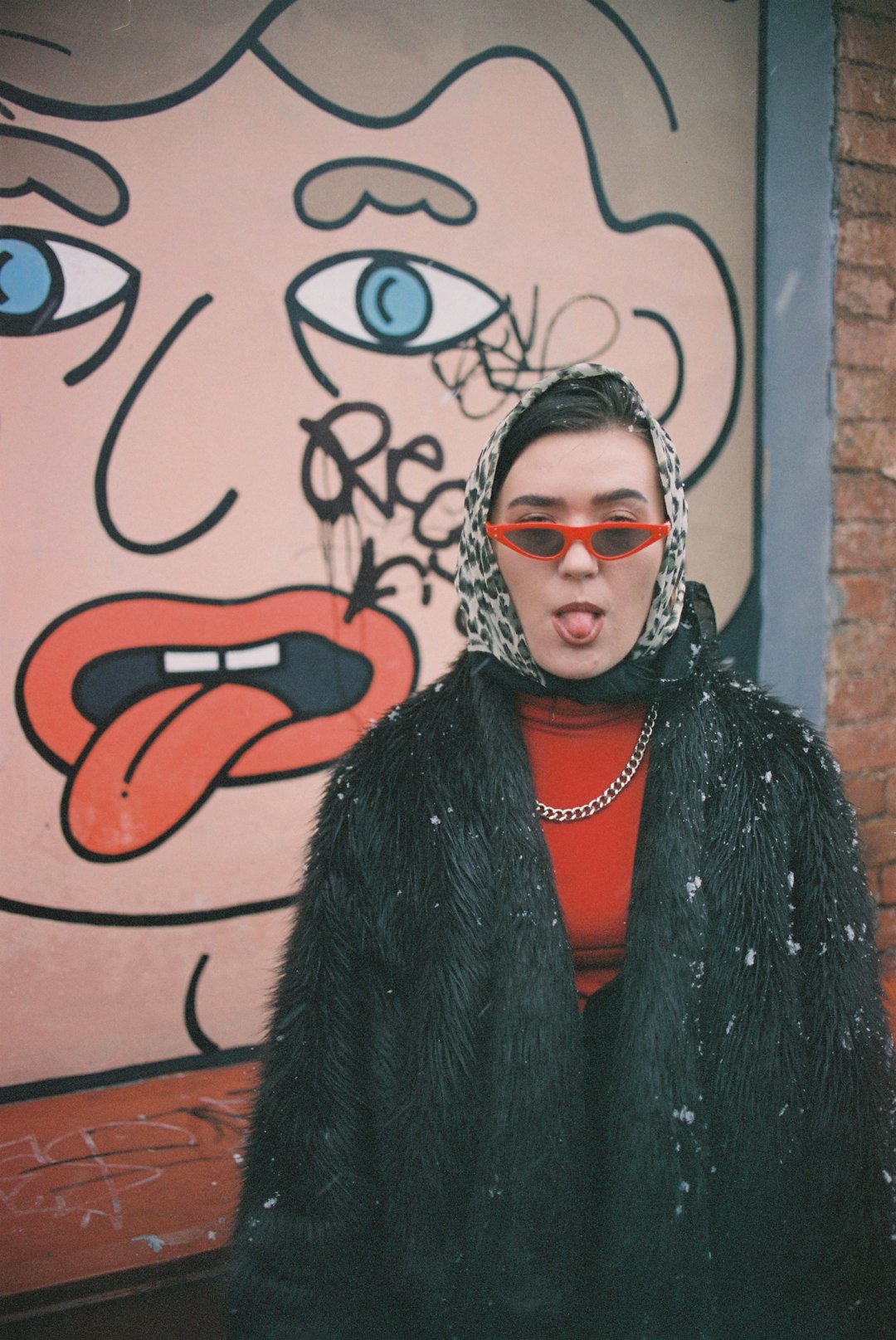 woman in black fur coat wearing black framed eyeglasses