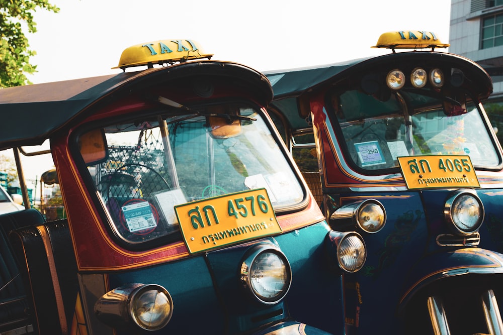 blue and yellow car with yellow taxi license plate