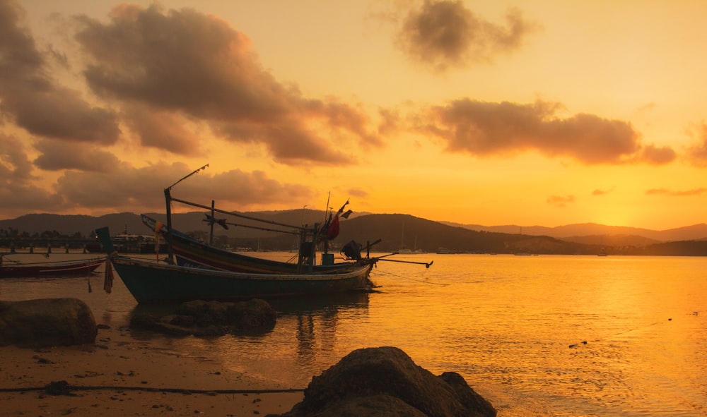 boat on sea during sunset