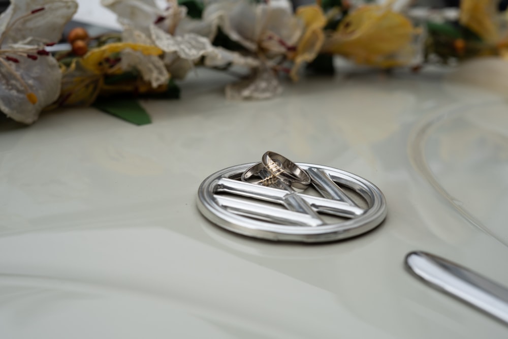 silver round accessory on white table