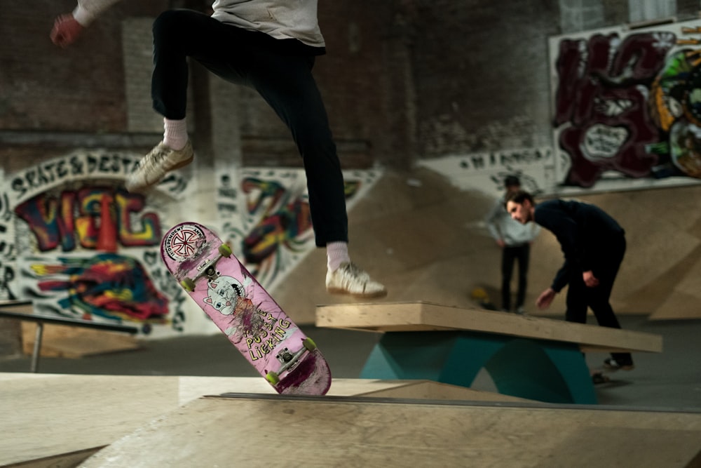 man in white shirt and black pants riding skateboard