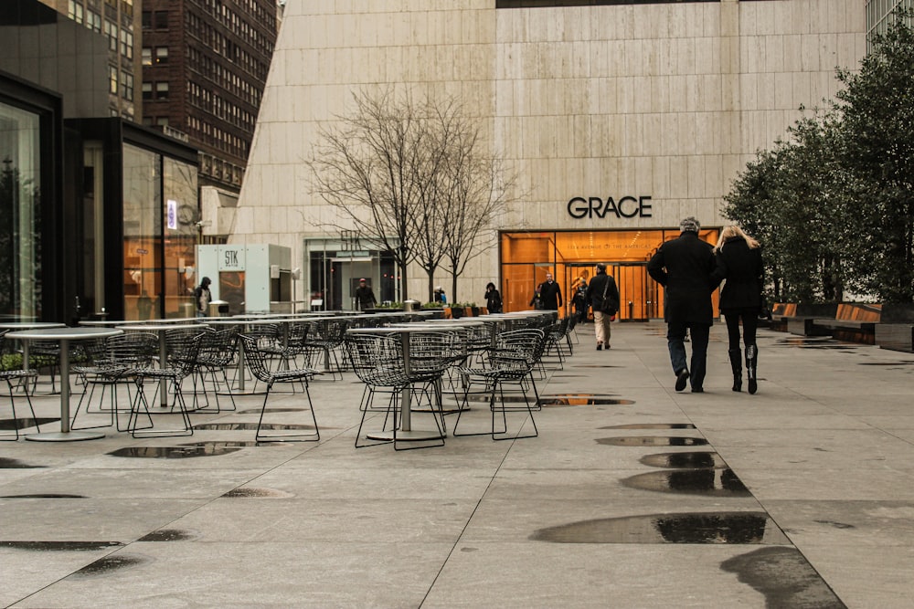 people walking on sidewalk near building during daytime