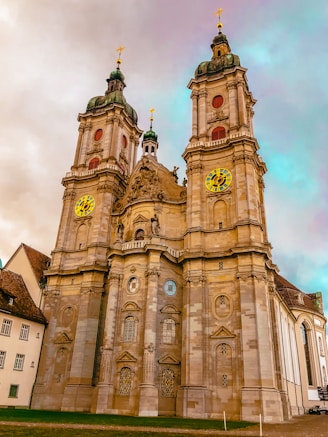 brown concrete church under cloudy sky during daytime