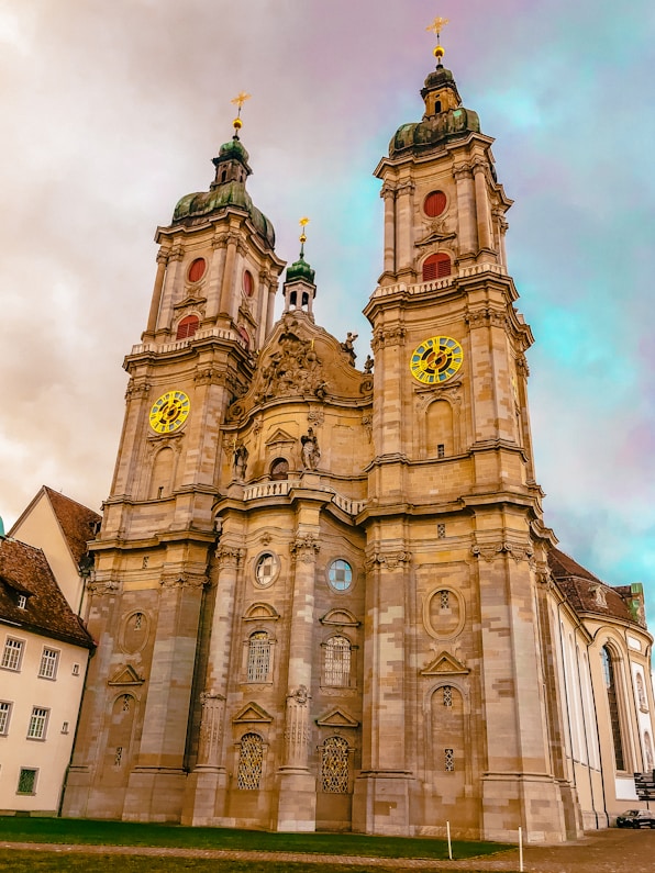 brown concrete church under cloudy sky during daytime