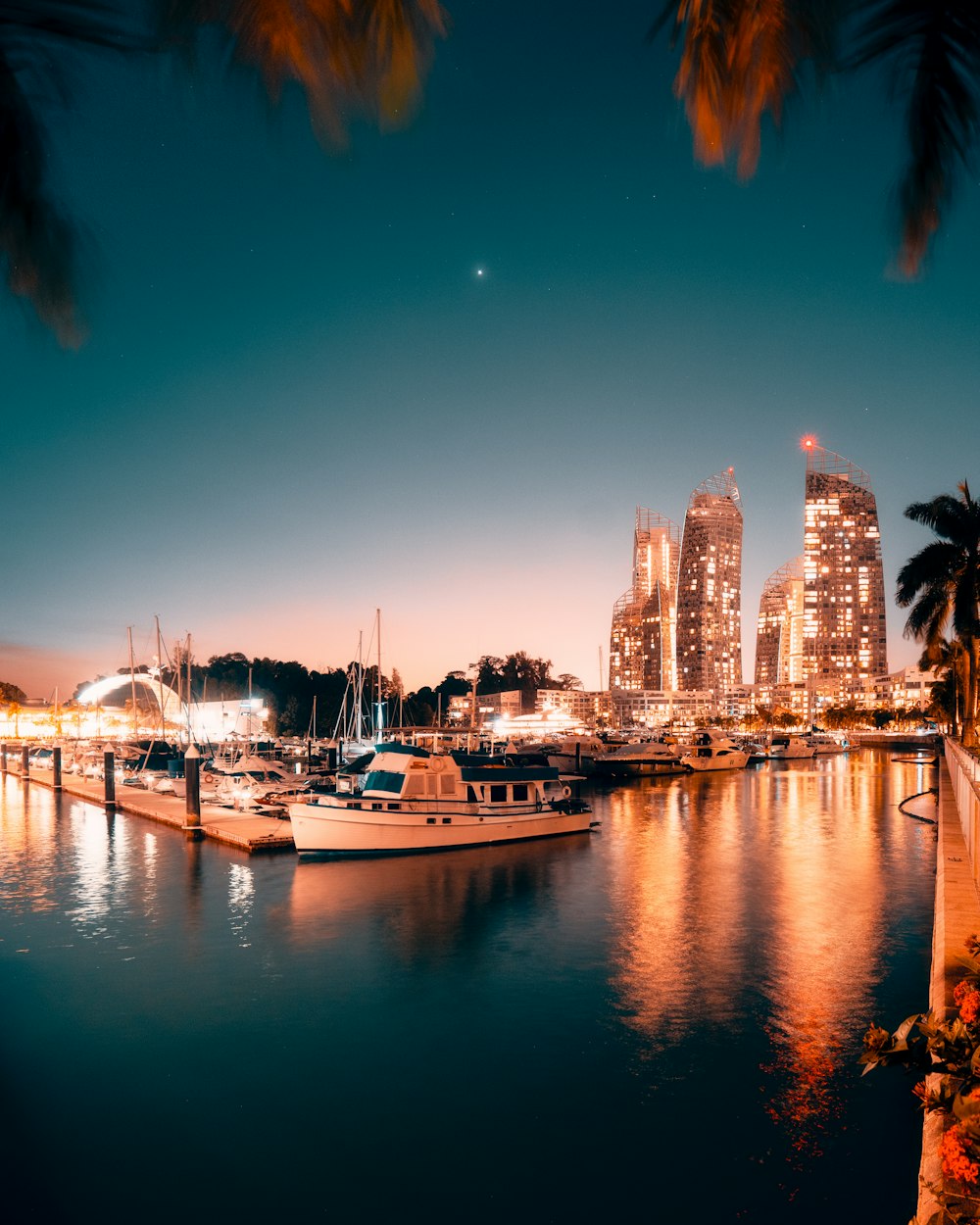 white and blue boat on body of water during night time