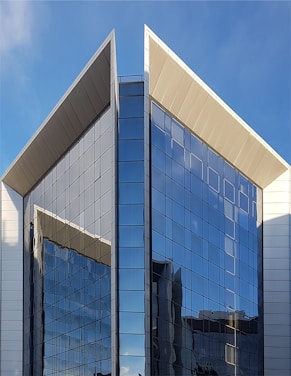 white and blue concrete building under blue sky during daytime