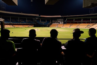people watching soccer game during nighttime