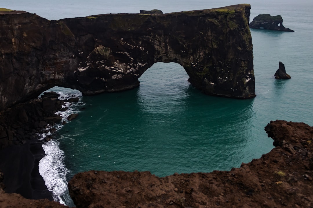 Natural arch photo spot Vik Dyrhólaey Light