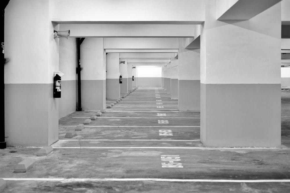 grayscale photo of hallway with columns