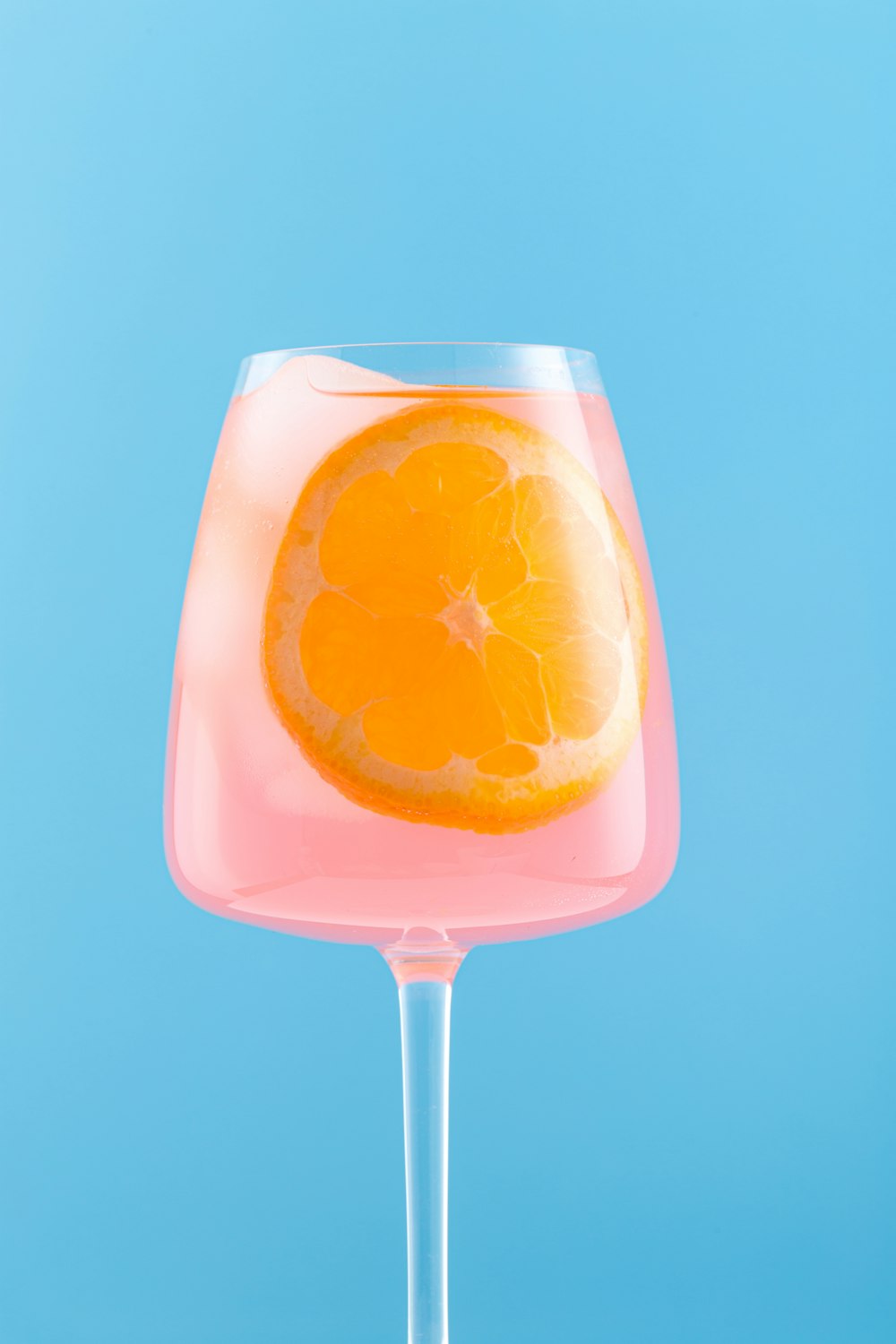 orange juice in clear drinking glass