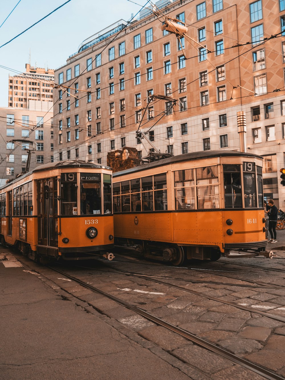 yellow and white tram on road near buildings during daytime