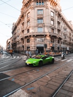 A compact city car cruising through a vibrant urban street in Australia.