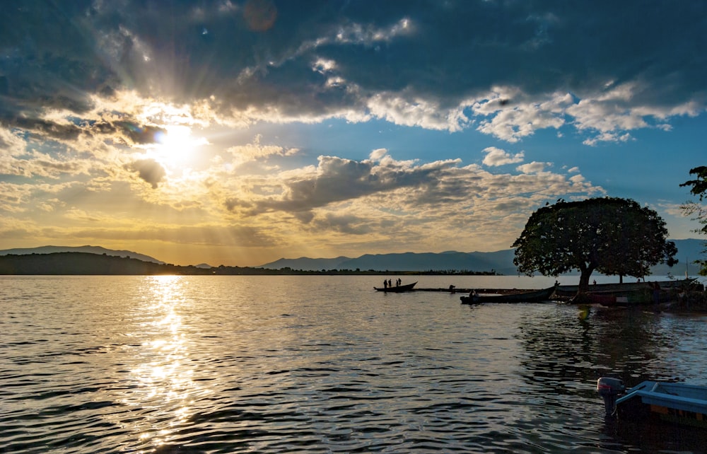 silhouette of people on boat on sea during sunset