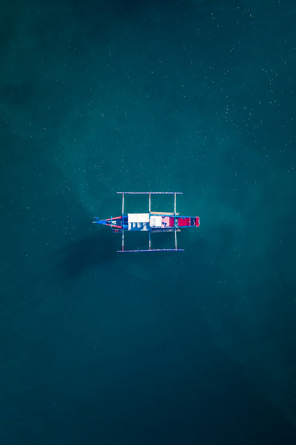 white and red boat on body of water