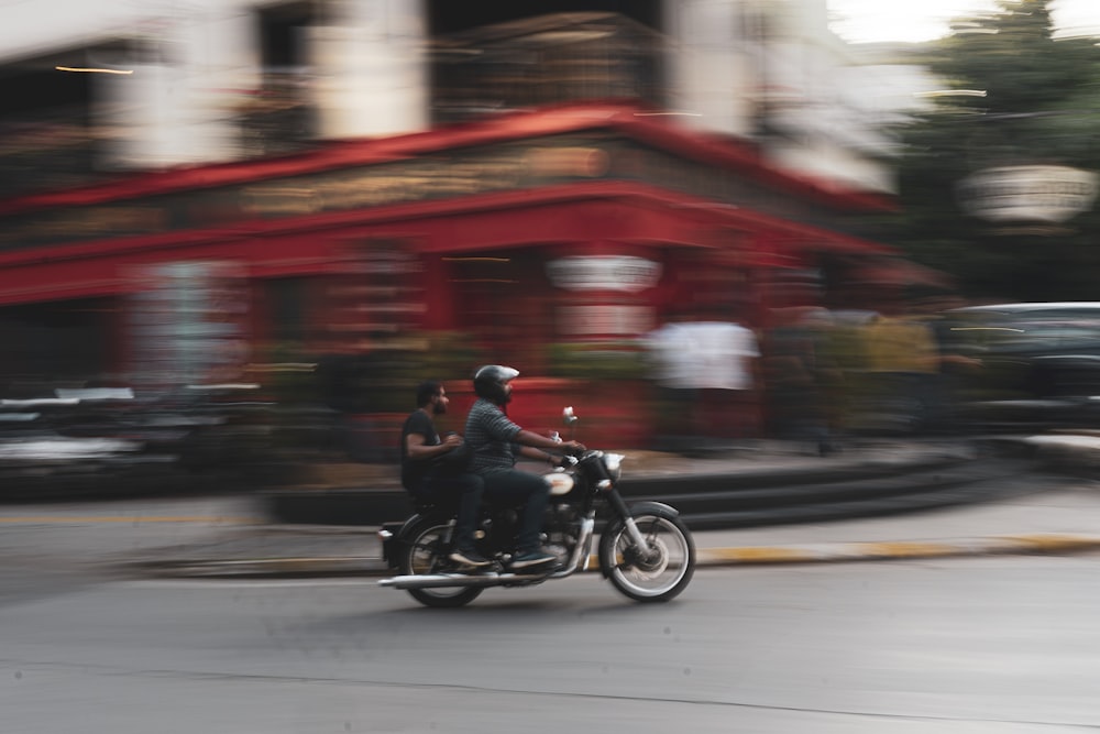 man riding motorcycle on road during daytime