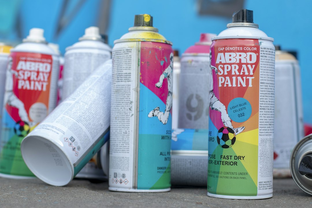 white and green labeled spray bottle,