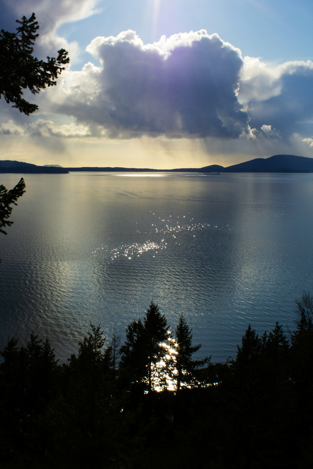 body of water near mountain during daytime