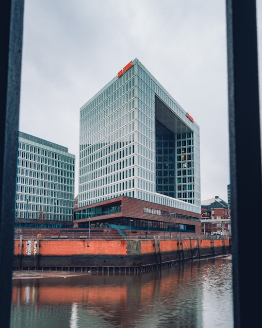 white concrete building near body of water during daytime in HafenCity Germany