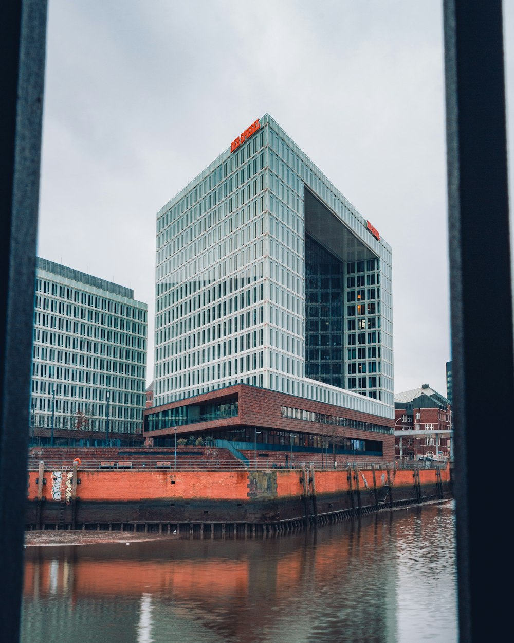 white concrete building near body of water during daytime