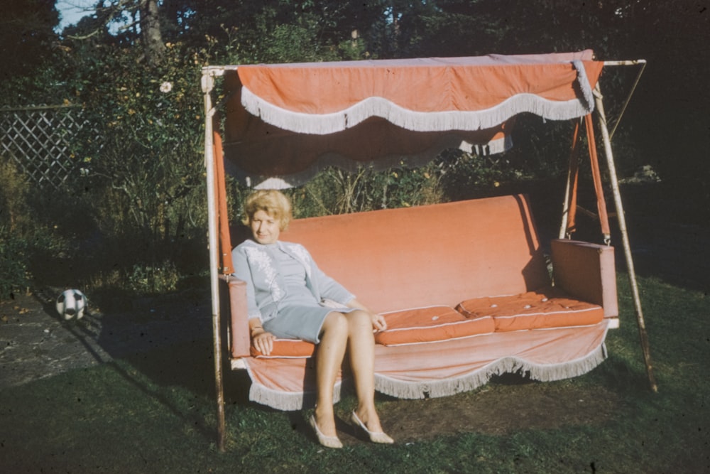 girl in pink t-shirt sitting on swing