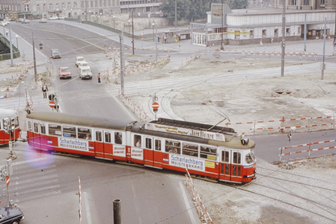 red and white train on rail road during daytime