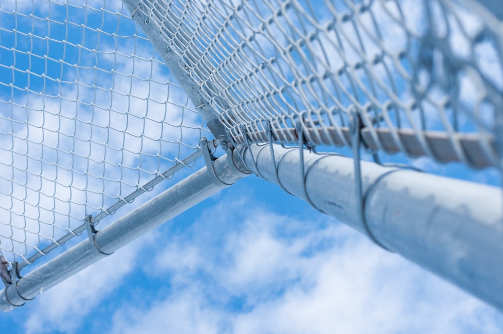 white metal fence under blue sky during daytime