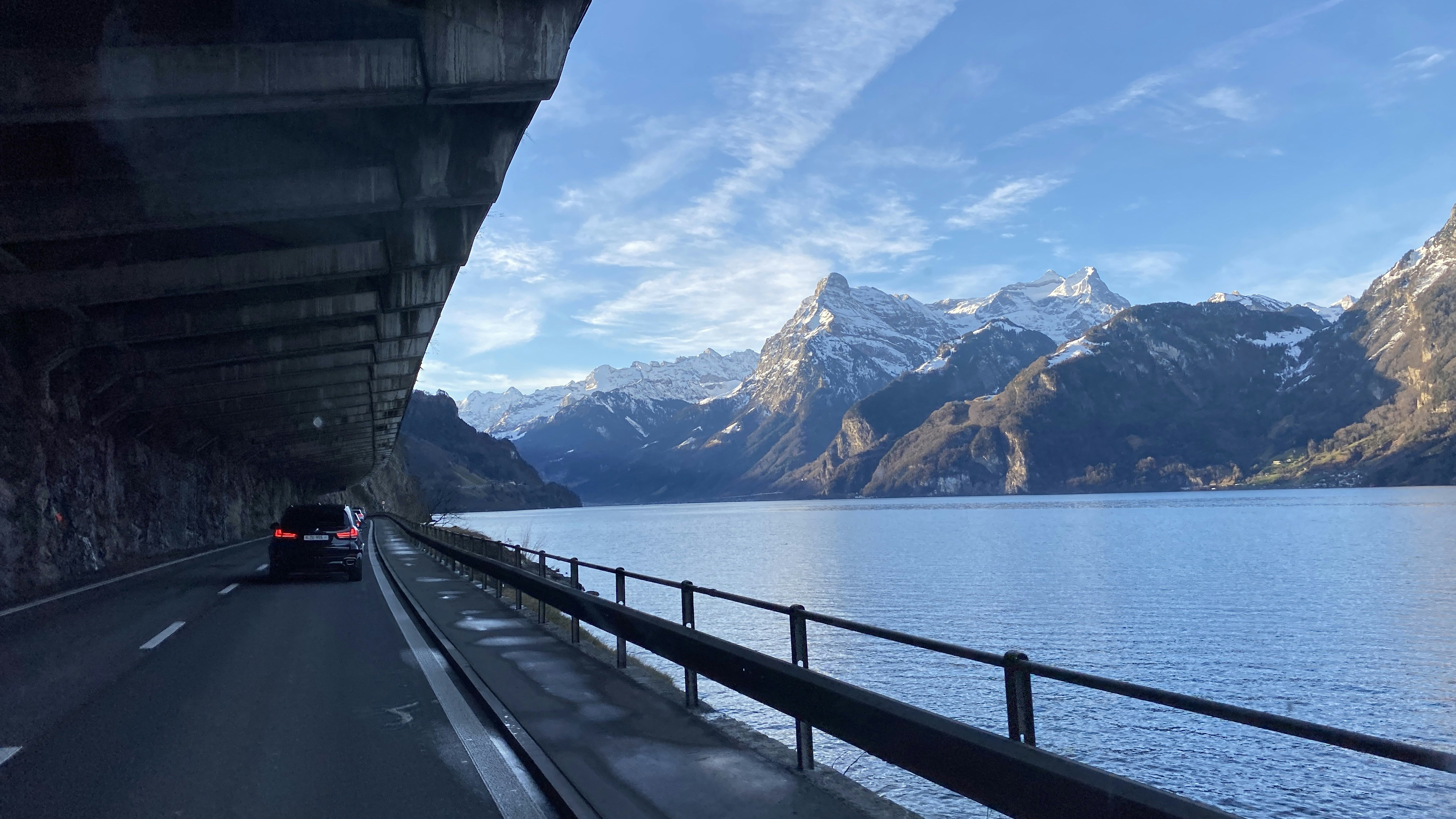 gray concrete bridge across body of water during daytime