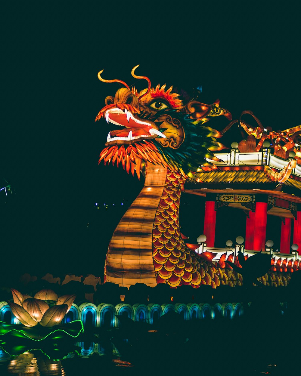 dragon with blue lights on top of building