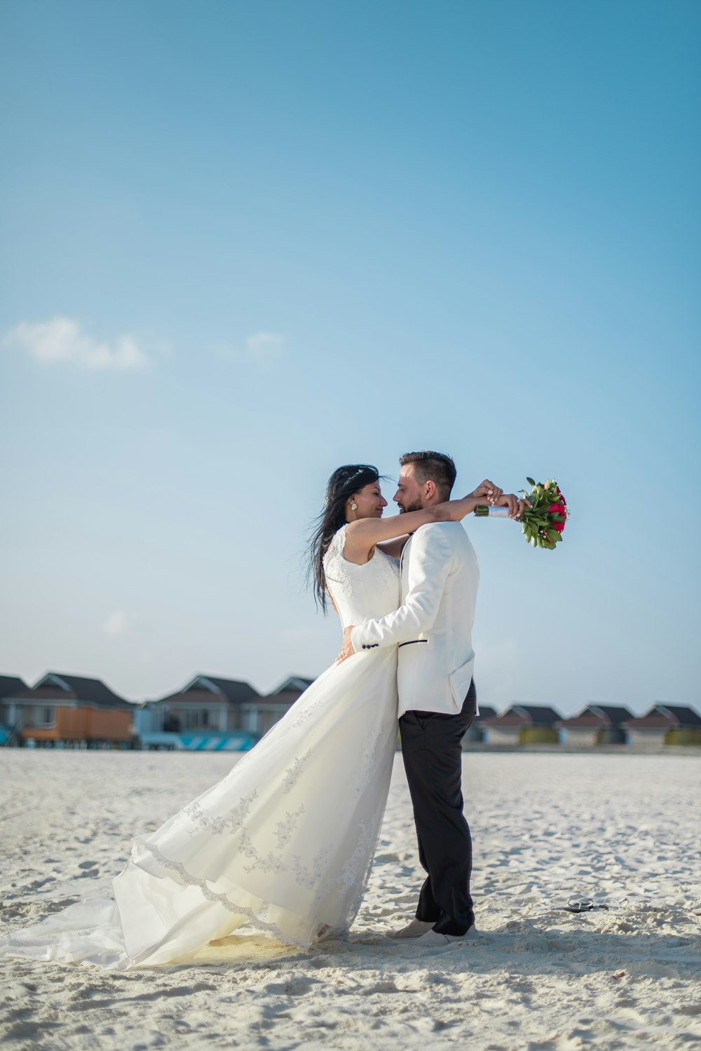 woman in white wedding gown holding bouquet of flowers