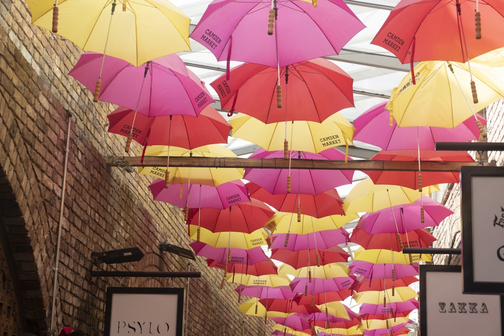 orange umbrella on brown brick wall