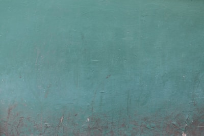 A vibrant wall freshly painted in a rich teal color showcasing smooth, even coverage.