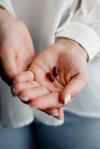 person holding brown and black round ornament