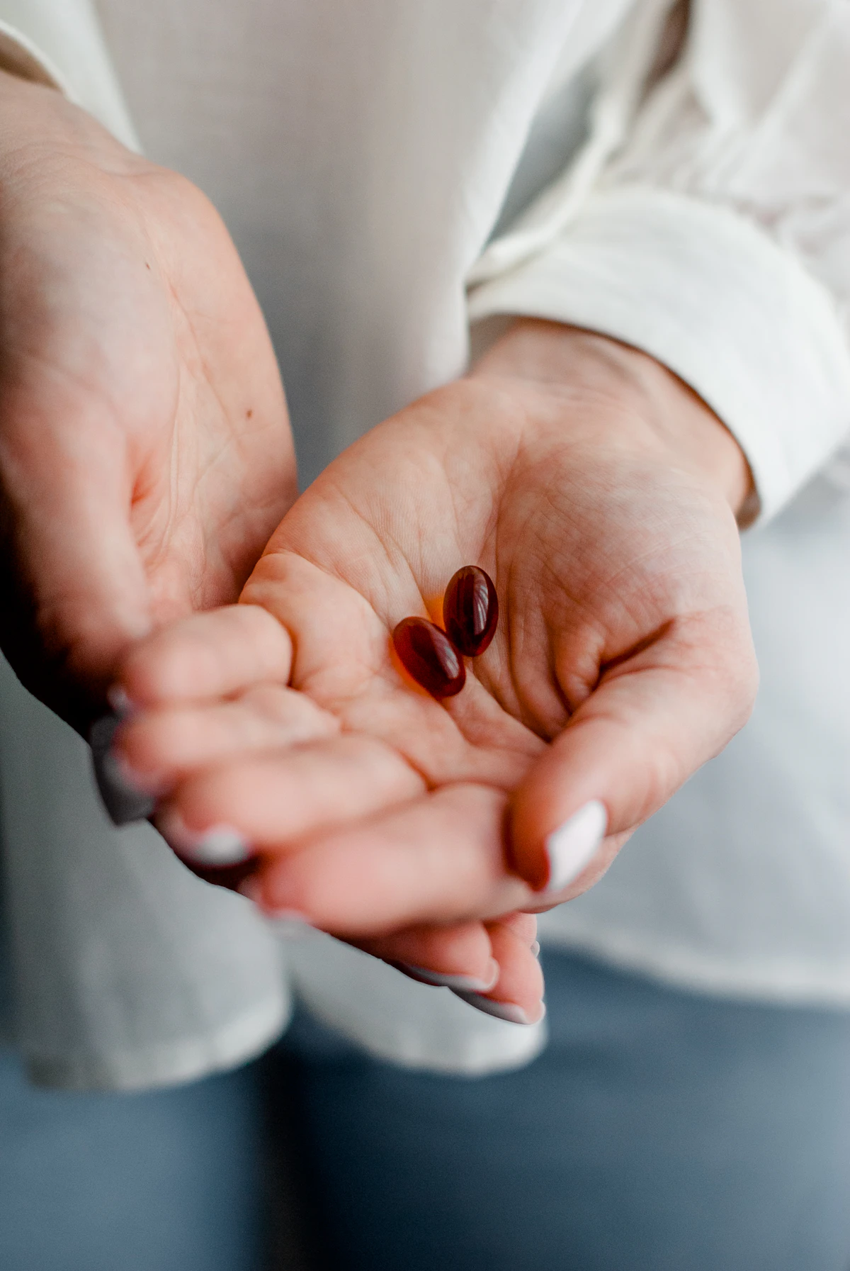Woman comparing two fertility supplement bottles while planning her daily routine