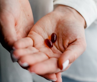 person holding brown and black round ornament