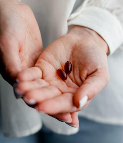 person holding brown and black round ornament