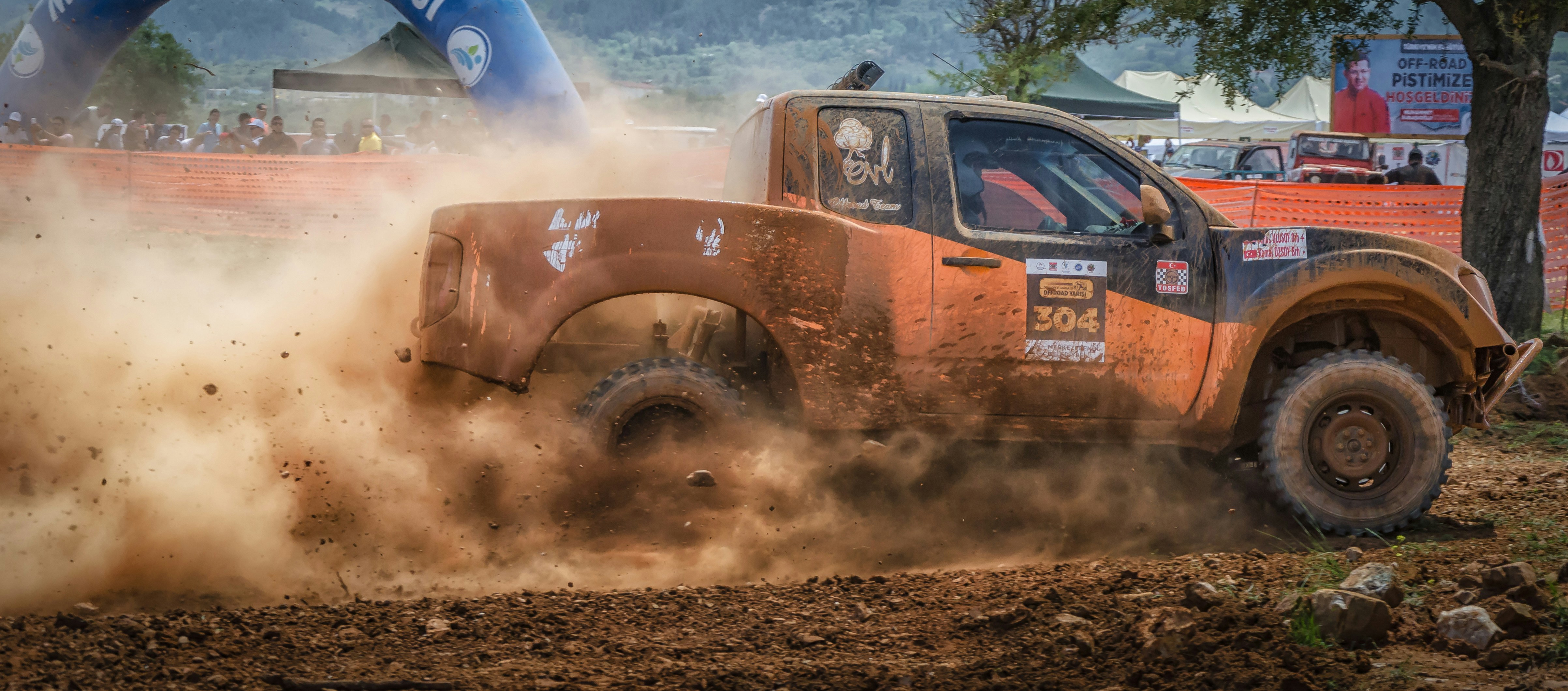 red and black car on brown soil