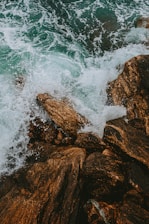 brown rock formation on sea during daytime