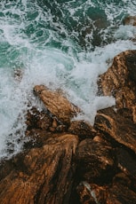 brown rock formation on sea during daytime