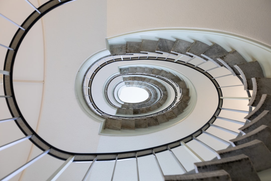 white spiral staircase with black metal railings