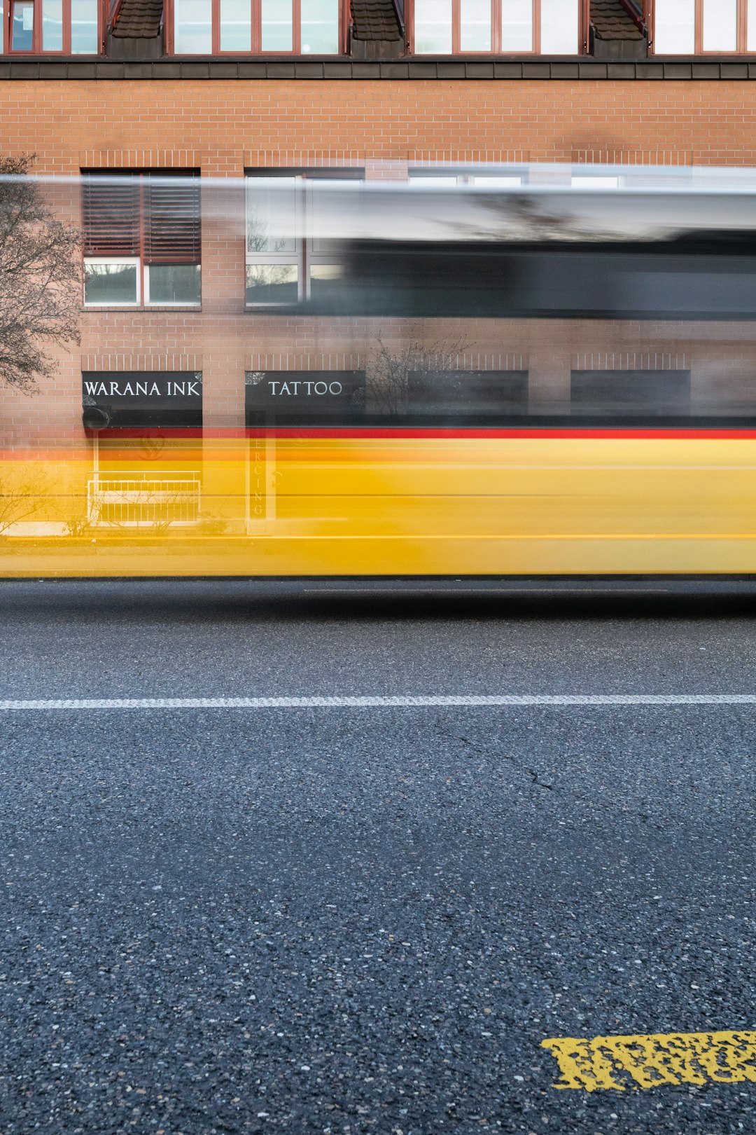 yellow and black bus on road during daytime