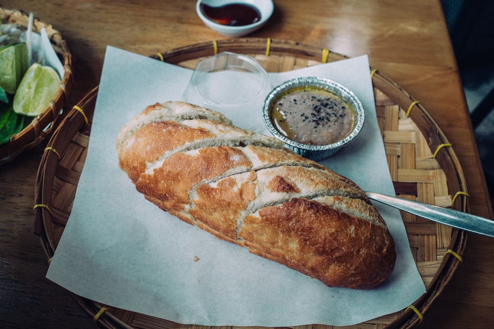 bread on white paper beside white ceramic plate