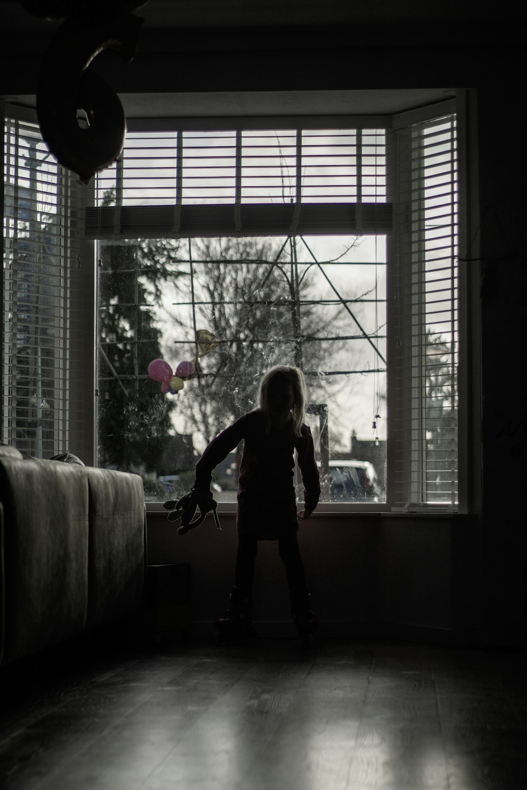 girl in black long sleeve shirt and black pants standing on window