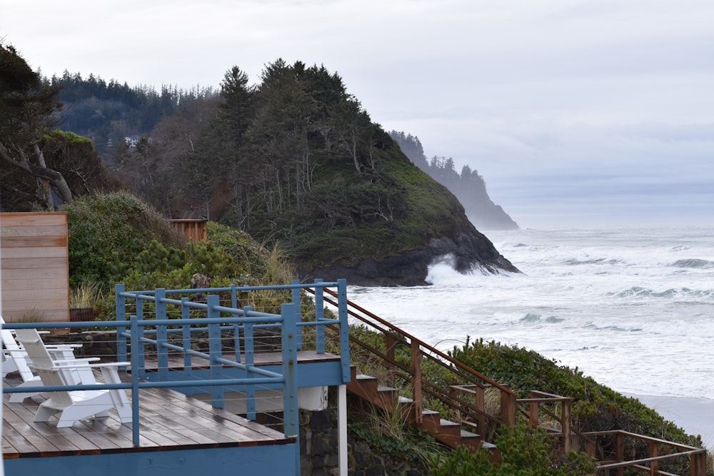 blue wooden fence near body of water during daytime