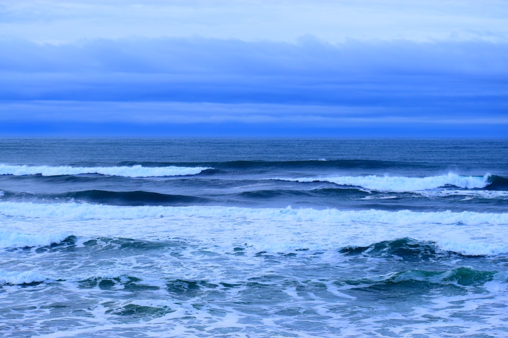 ocean waves under blue sky during daytime