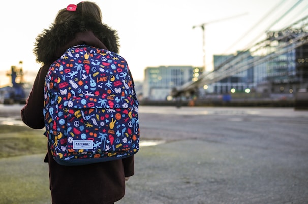 A vibrant city backdrop with a model sporting a trendy, functional backpack from accufinrtech.