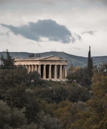 brown concrete building under white clouds during daytime