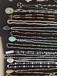 A variety of necklaces displayed on a wooden surface.