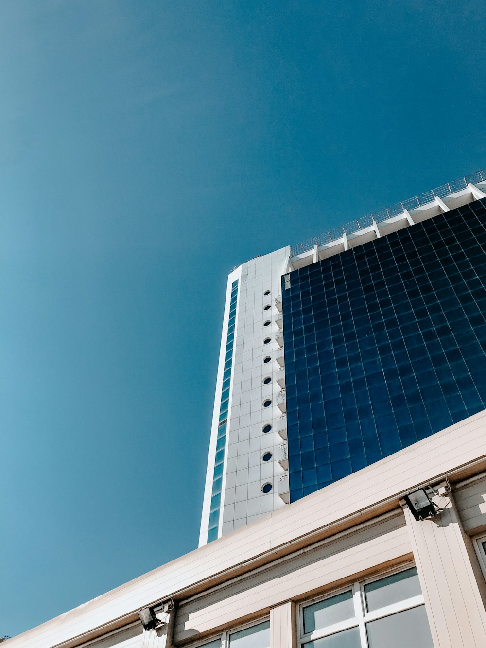 blue glass walled high rise building