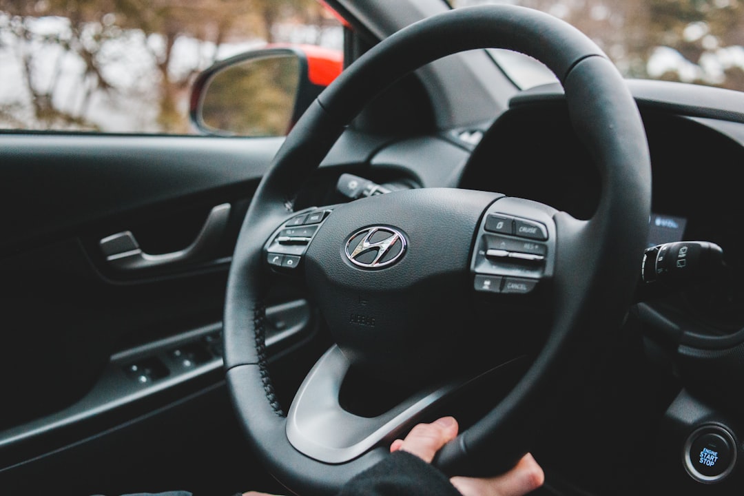person holding black mercedes benz steering wheel