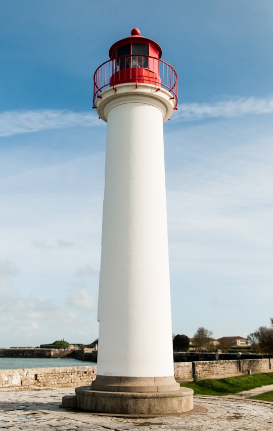 white and red concrete tower under blue sky during daytime in Âne en culotte France